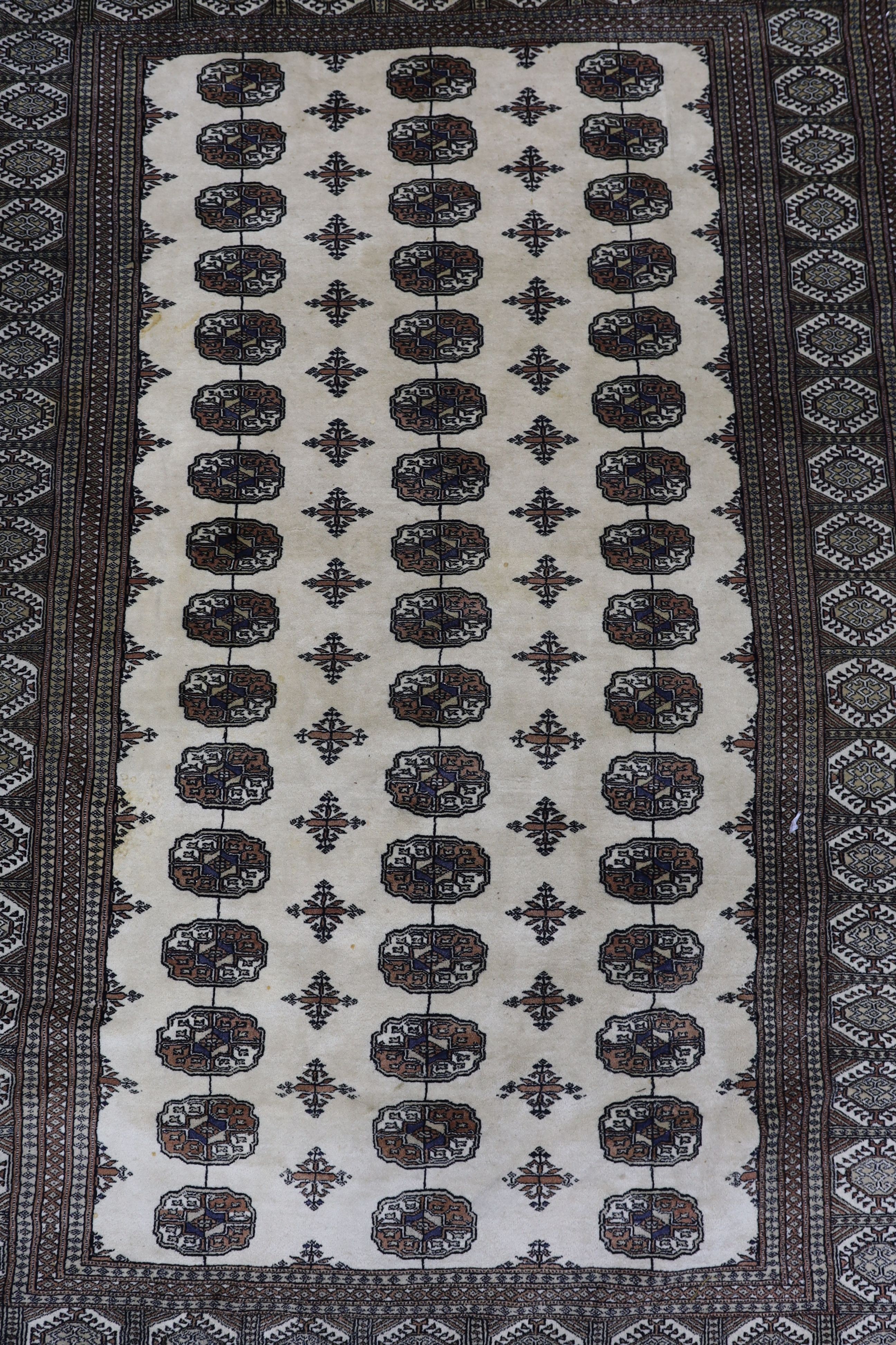 A Bokhara ivory ground rug, 246 x 156cm